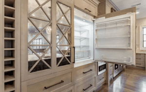custom built cabinetry on a fridge that features unique metal and glass accents