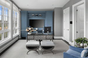 a home office with blue built-in custom cabinetry